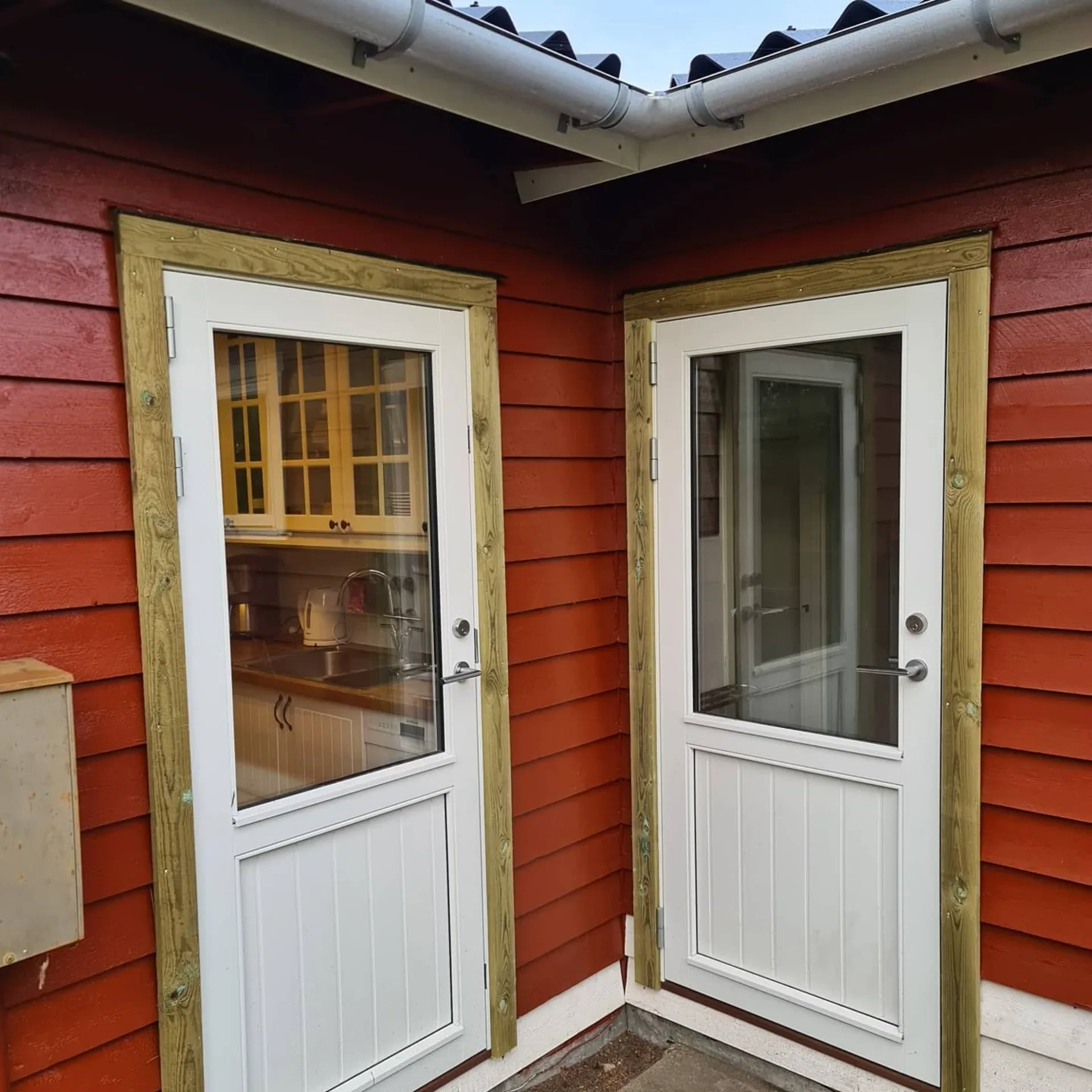 Udendørs trædøre med glasvinduer til firmaindgang.